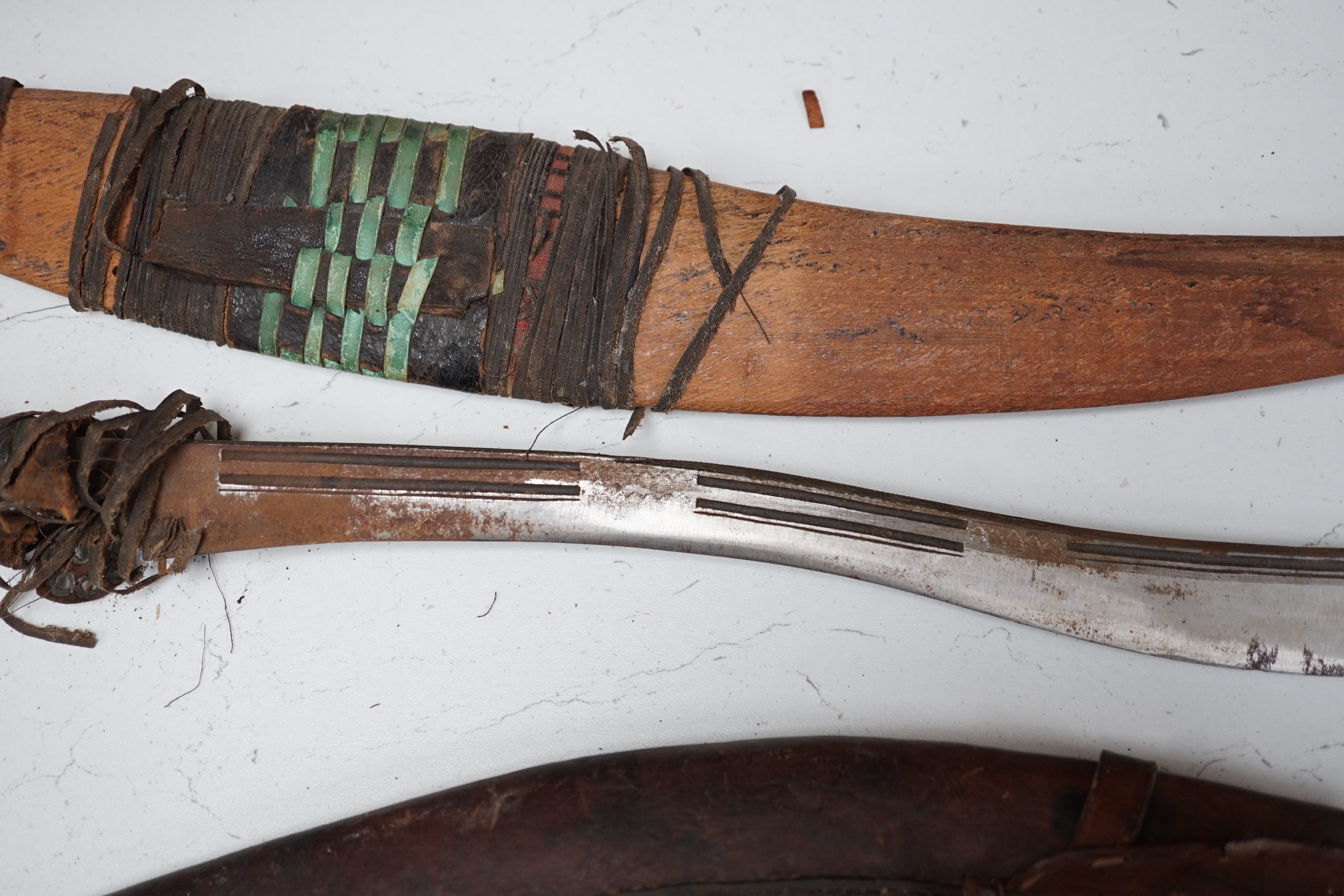 A kukri, a long dagger and sheath, a mace, and two African ebony busts